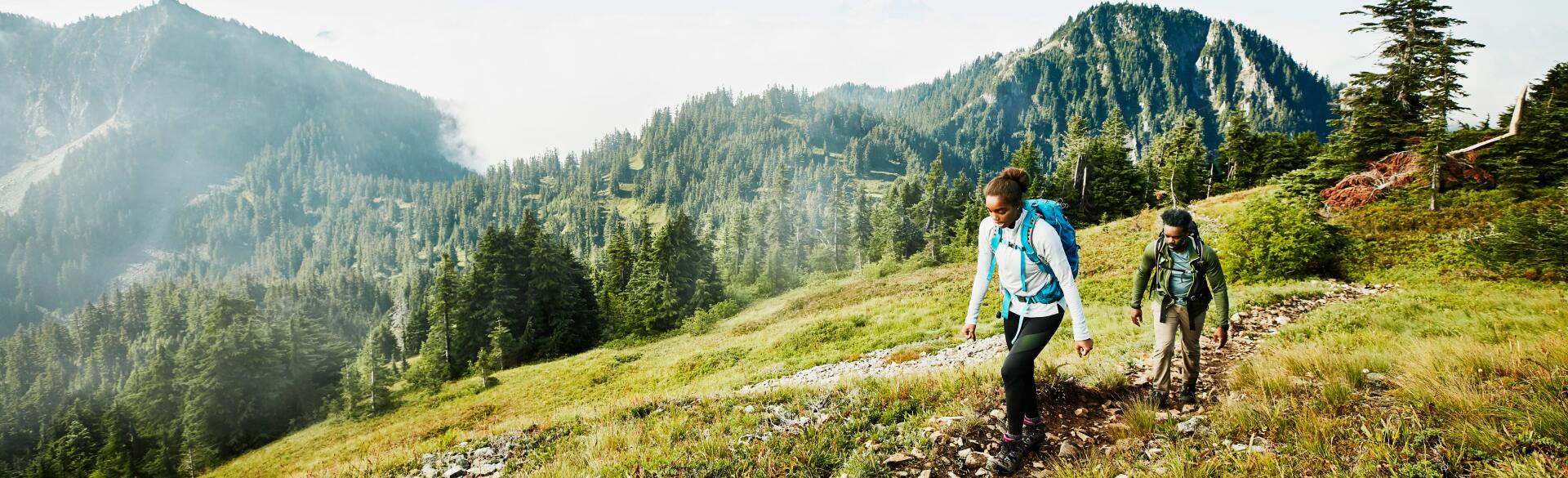 Female and male hiking in the mountains
