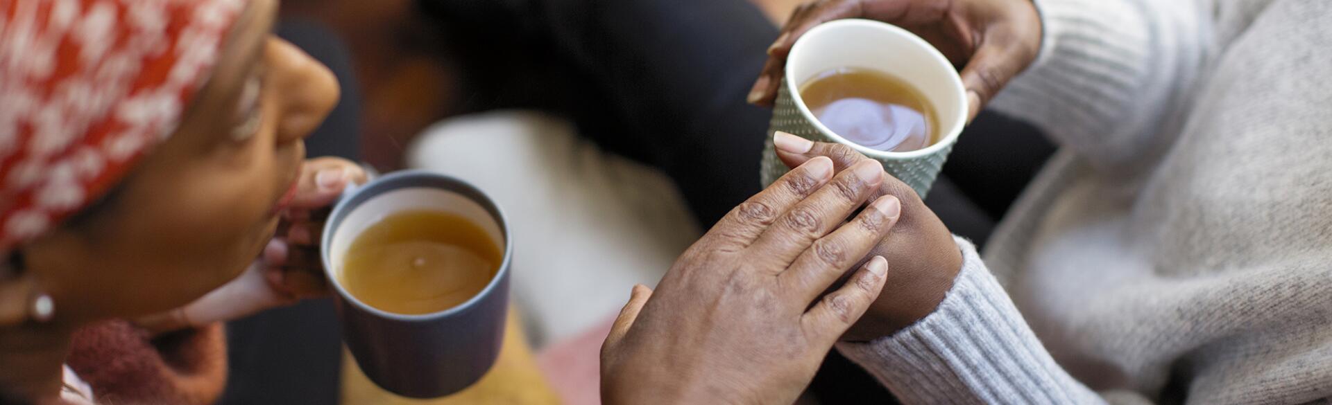 Women friends talking, drinking tea