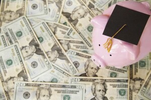 piggy with graduation cap on money