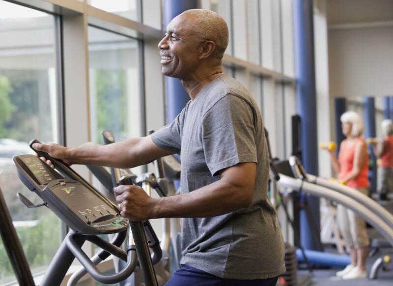 African man working out on elliptical machine