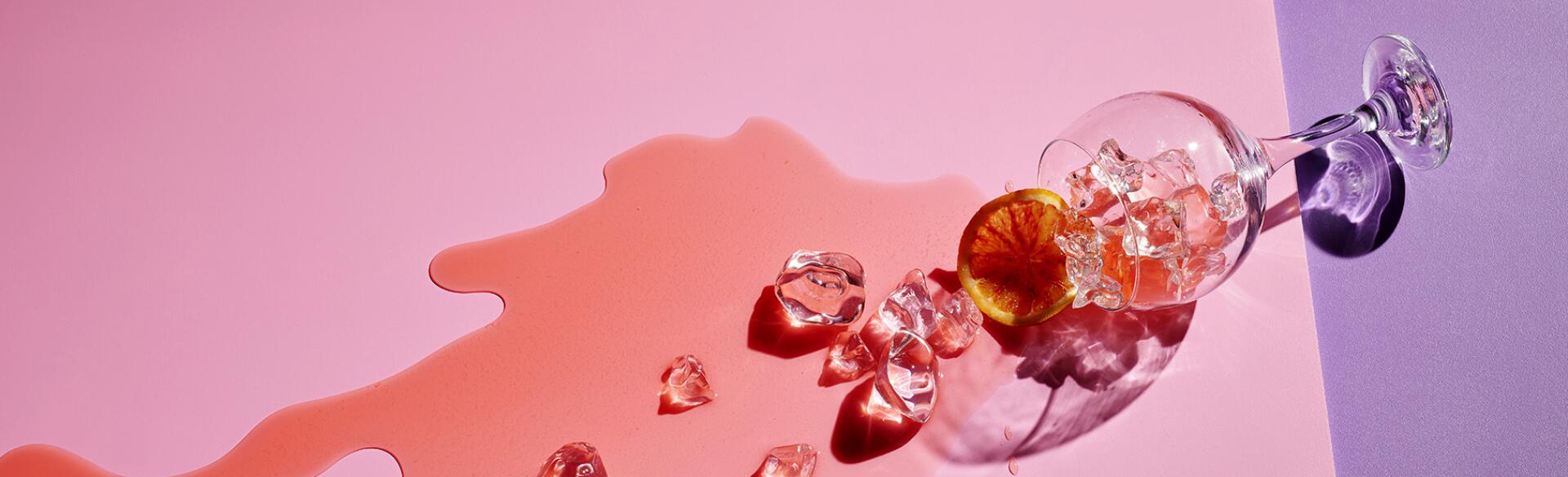 spilled cocktail on pink and purple background