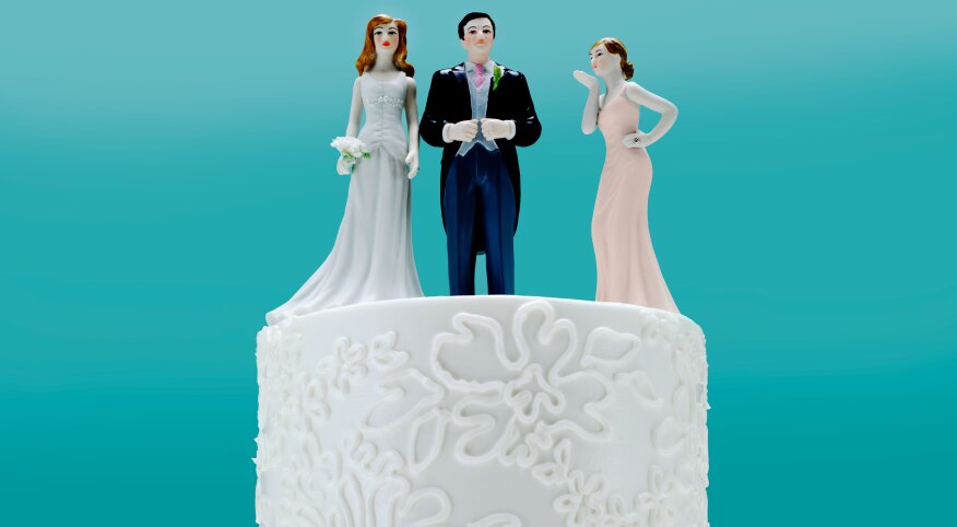 Wedding Cake with 3 toppers, a couple and a 2nd woman.
