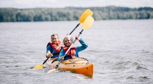 Senior couple kayaking on lake