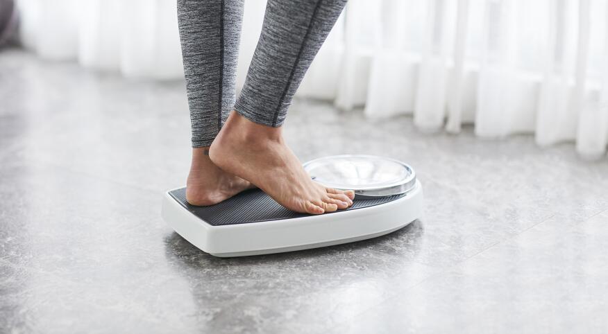 woman using a scale at home