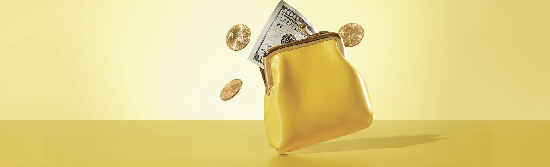 yellow coin purse with money and coins coming out of it