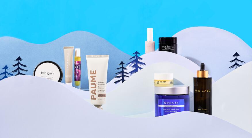Beauty skincare products styled within cut paper winter scene