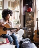 image_of_woman_playing_the_guitar_GettyImages-694757290_1800