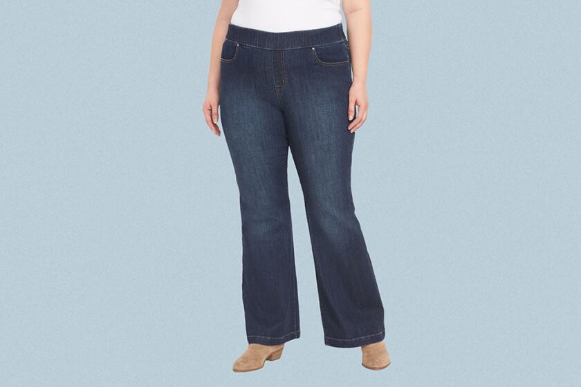 Woman wearing flare jeans on grey background