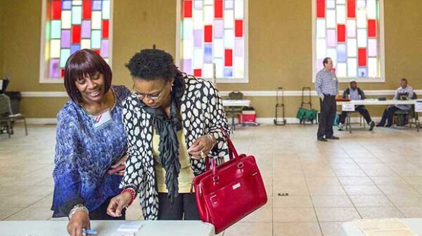 Sandy Haddock and Shirlee McCleskey talk at the Cathedral of Praise church, a polling station in Nashville, Tenn.