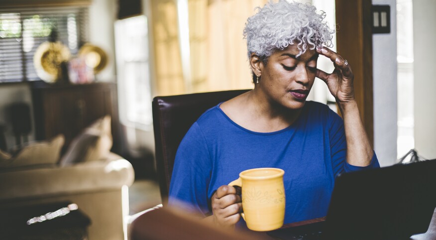 image_of_woman_sitting_at_computer_holding_her_head_GettyImages-1334573191_1800