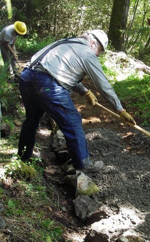 Volunteer works the soil