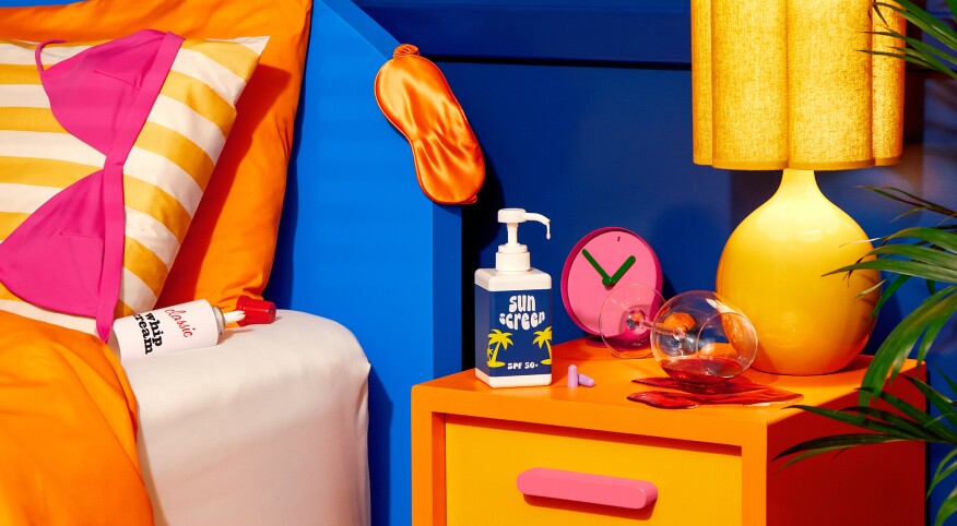 Bright colored bedroom scene with knocked over wine, whip cream and dripping sunscreen