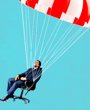 Man in work chair attached to parachute