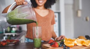 image_of_woman_pouring_green_smoothie_GettyImages-1185840420_1800