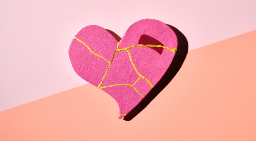 Pink kintsugi pottery shaped heart on colorful background