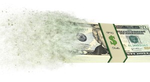 Stack of 20 dollar bills going up in smoke