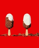Ice cream bars with chocolate chipped away revealing vanilla ice cream 