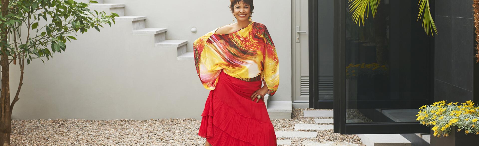 Hispanic woman standing on steps over pond