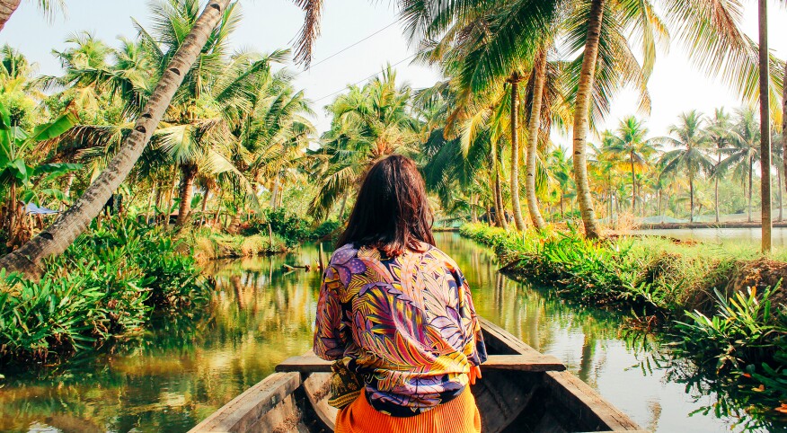 Woman Kayaking Through the Backwaters of Monroe Island, Kerala, South India