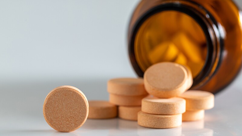 A close-up of vitamin pills on a white background