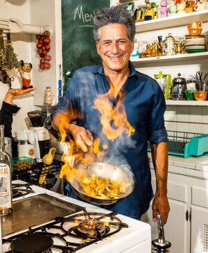 Bob Blumer in kitchen with frying pan on fire