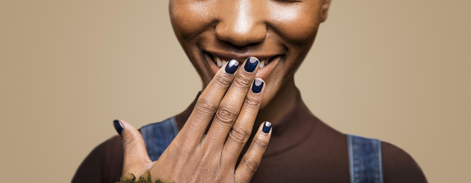 Women with hand in front of her face showing her manicure