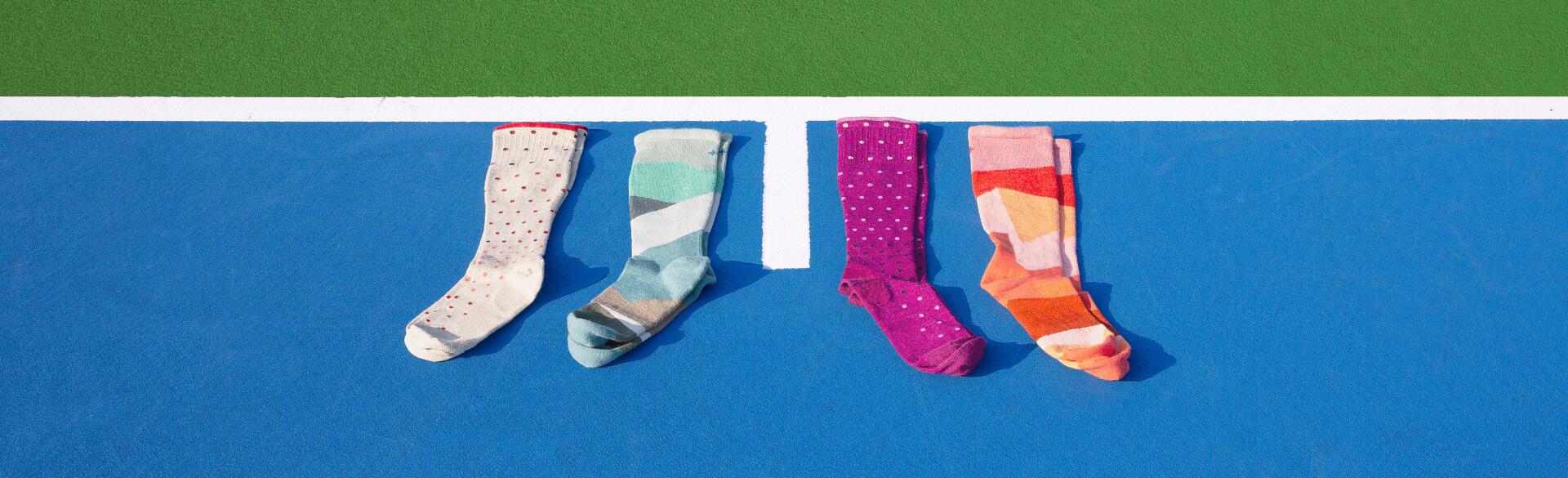 compression socks photographed on a blue tennis court