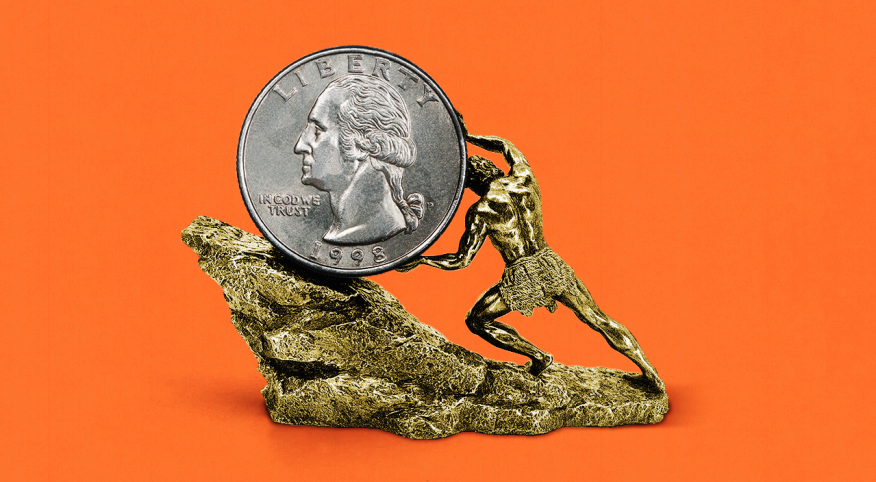 man pushing a larger coin up a rock