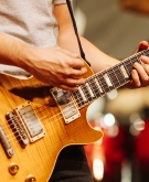 Musician playing guitar in live concert 