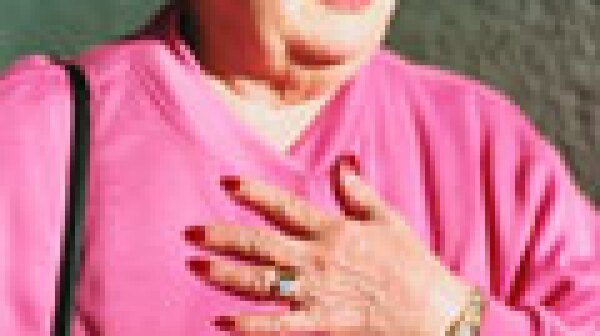 Hooked on Heartburn Medication- woman holding her chest in discomfort