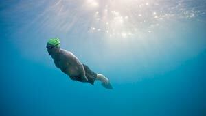 A man swims underwater
