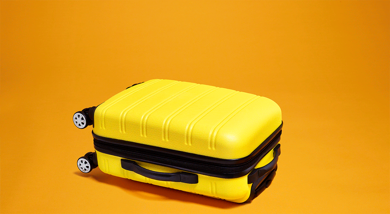 GIF of yellow suitcase on yellow background, opening up to show travel scene