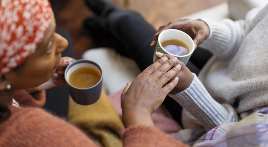 Women friends talking, drinking tea