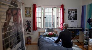 Empty nester father sits in child's bedroom