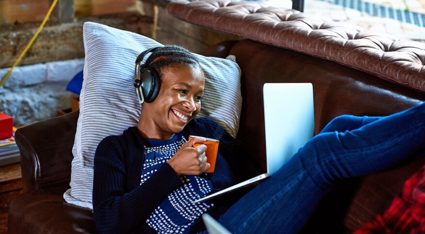 image_of_woman_laying_on_sofa_with_laptop_GettyImages-1145041102_1800