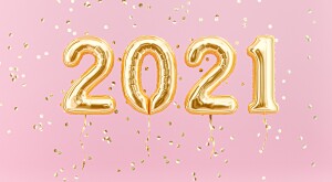 New year 2021 celebration. Gold foil balloons numeral 2021 and confetti on pink background. 3D rendering