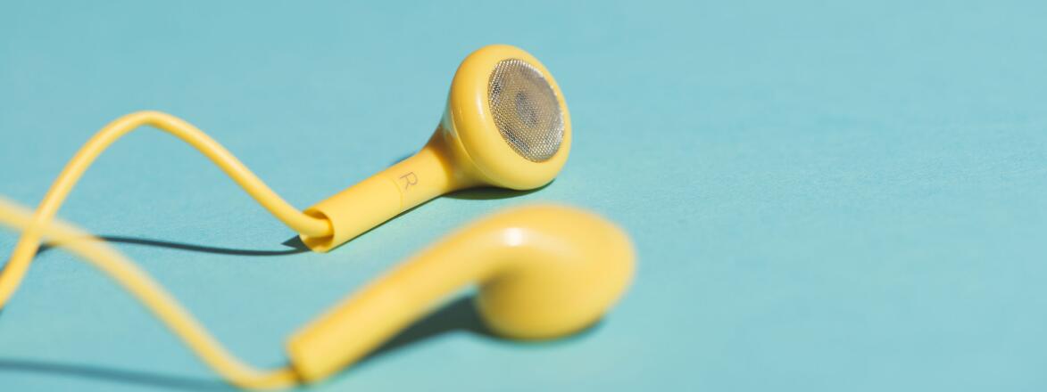 Yellow headphones on a teal background