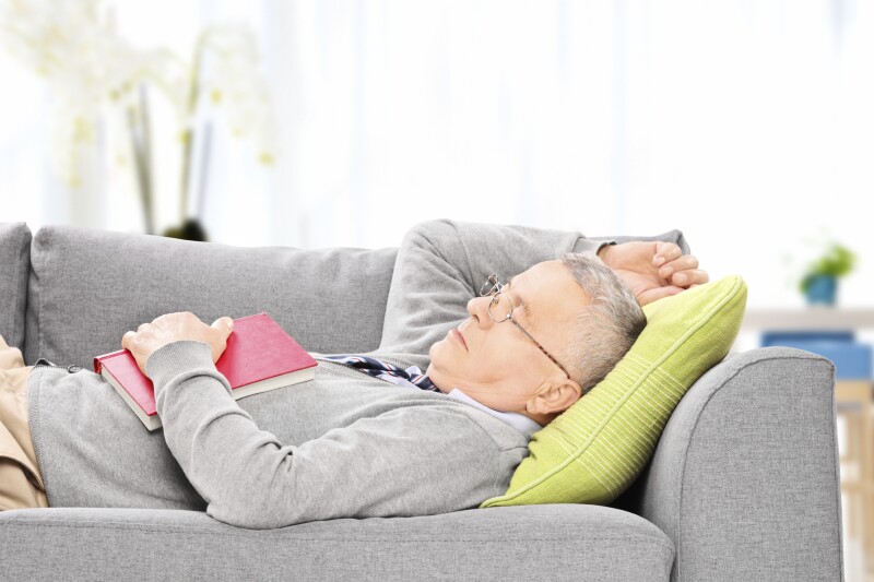 Senior man sleeping on sofa
