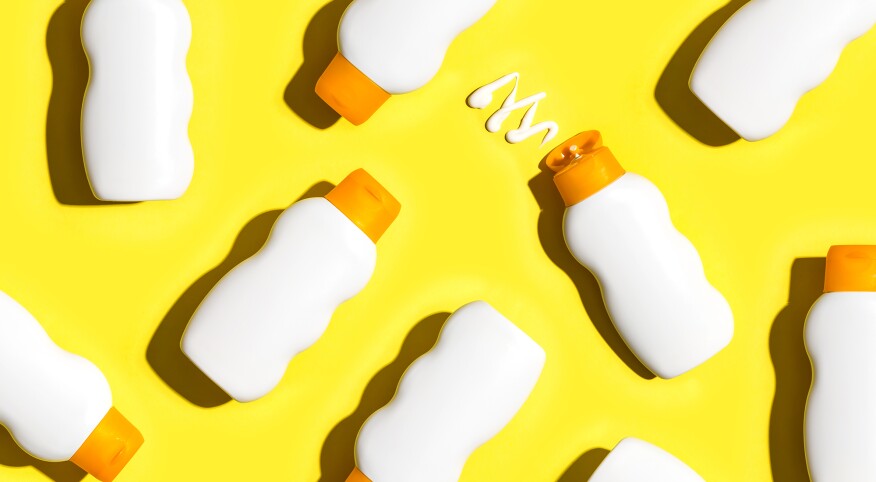 Sunscreen products on yellow background
