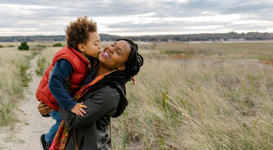 image_of_black_mother_holding_small_child_against_landscape_Stocksy_txpf9d9135aWFX200_OriginalDelivery_1284835_1540.jpg