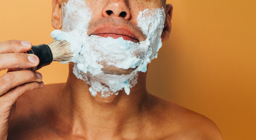 man applying shaving cream to his face