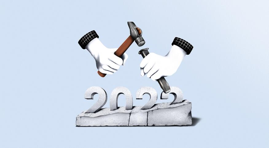 illustration of hand carving the year 2022 out of stone
