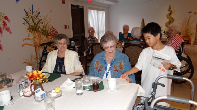 Family of four lives in assisted living. They say everyone benefits: their kids; current and prospective residents; and family caregivers