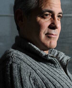 George Clooney poses for a portrait wearing a grey sweater at the Carlyle, a Rosewood Hotel on Wednesday February 05, 2014 in New York, NY
