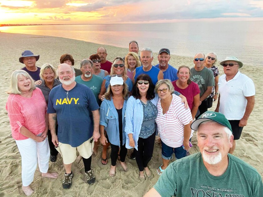 Group of friends from 55+ Community on the beach at sunset