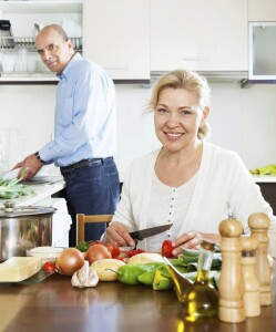 Older couple preparing healthy meal with fresh vegetables