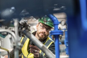 Manufacturing worker analyzing machines at factory