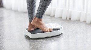 woman using a scale at home