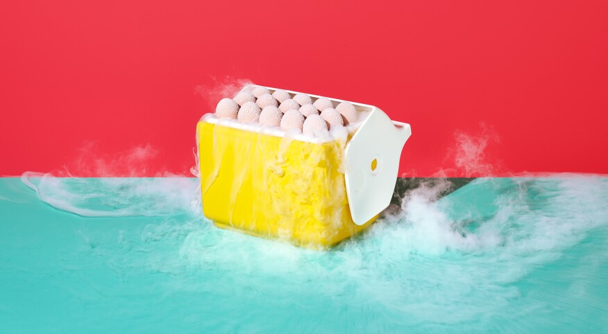 Frozen eggs with cold smoke in a yellow cooler