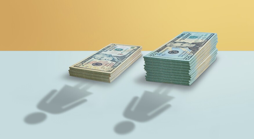 two women silhouettes by different amount stacks of money